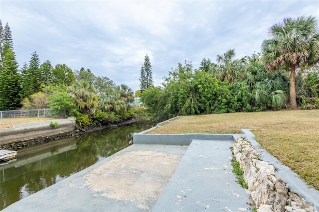 exterior space featuring a yard and a water view