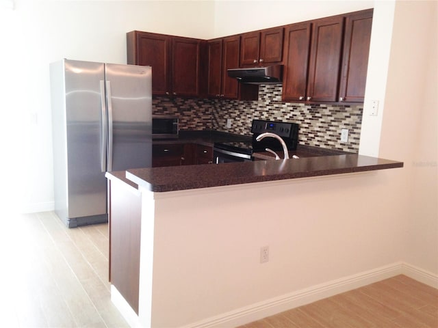 kitchen with backsplash, dark brown cabinetry, kitchen peninsula, and stainless steel appliances