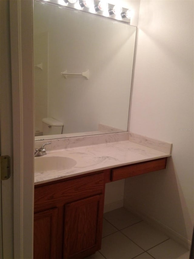 bathroom with tile patterned floors, vanity, and toilet