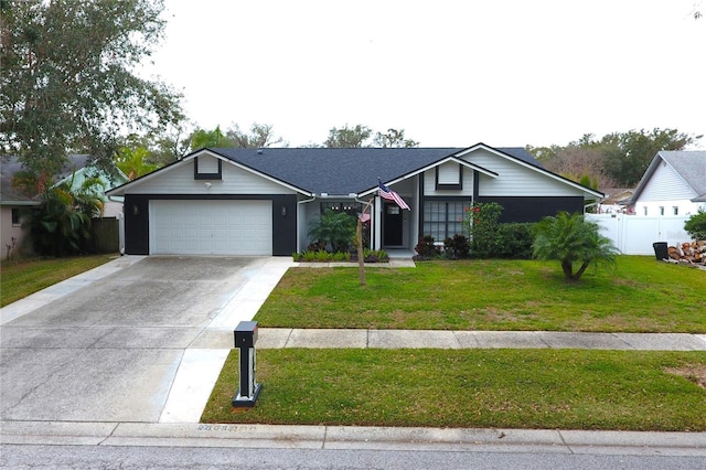 ranch-style home with a garage and a front lawn