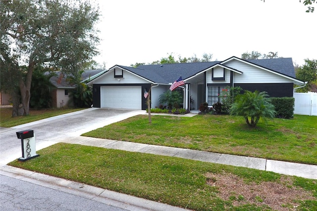 ranch-style house featuring a front yard and a garage