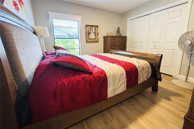 bedroom with a closet and hardwood / wood-style flooring