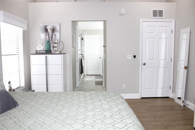 bedroom with hardwood / wood-style flooring