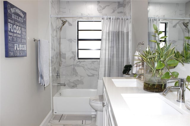 full bathroom with tiled shower / bath combo, vanity, and toilet