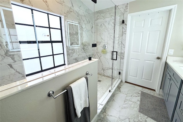 bathroom with vanity, a healthy amount of sunlight, and walk in shower