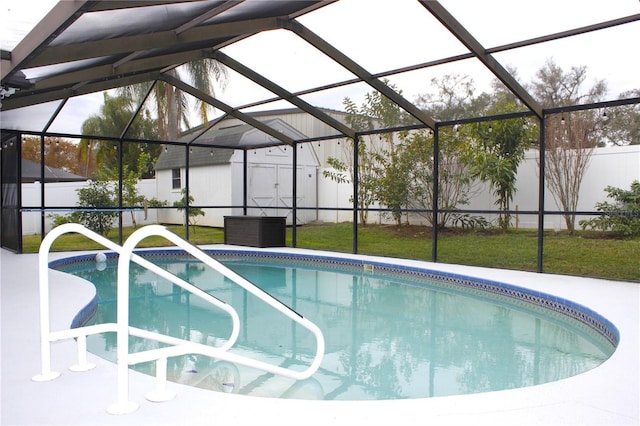 view of swimming pool featuring glass enclosure and a yard