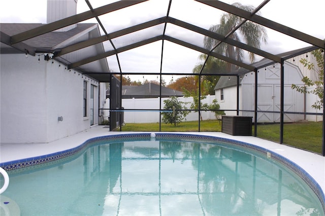 view of pool featuring glass enclosure