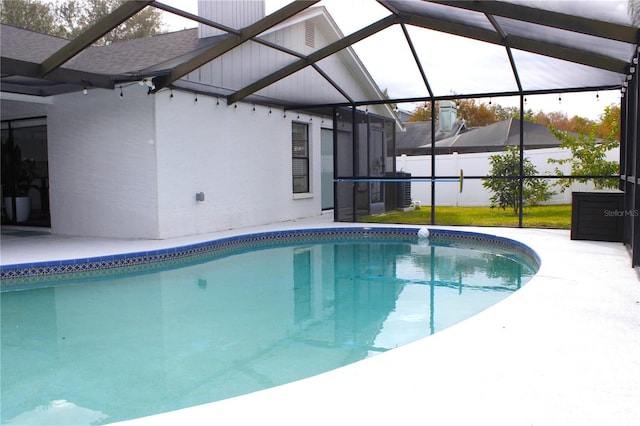 view of pool with a lanai and a patio area