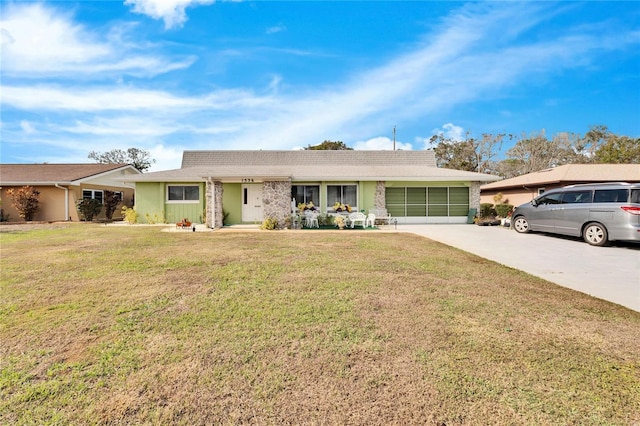 single story home featuring a front yard and a garage