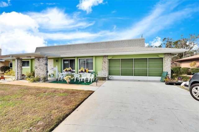 ranch-style home with a front lawn and a garage