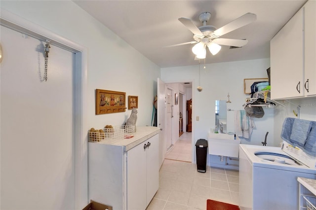 clothes washing area with light tile patterned floors, washer / dryer, cabinets, ceiling fan, and sink