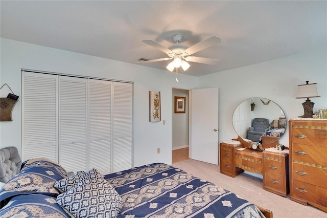 bedroom featuring a closet, ceiling fan, and light colored carpet