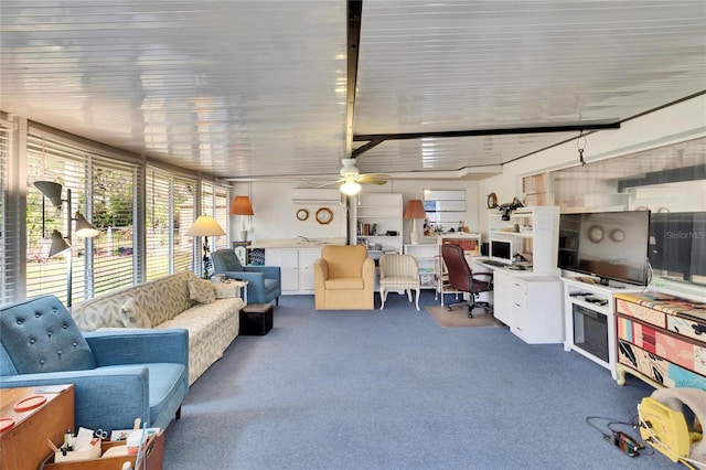 living room with ceiling fan and carpet flooring