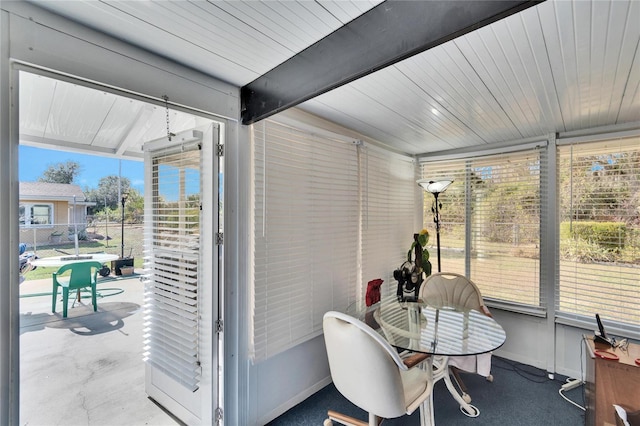 sunroom featuring beamed ceiling