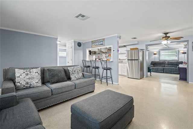 living room featuring ceiling fan and crown molding