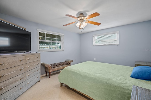 bedroom with ceiling fan and light colored carpet