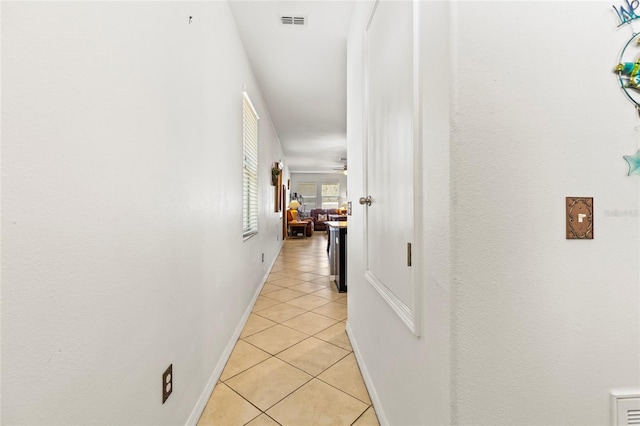 corridor with light tile patterned floors