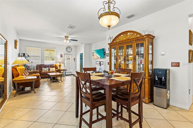 dining space with ceiling fan and light tile patterned floors