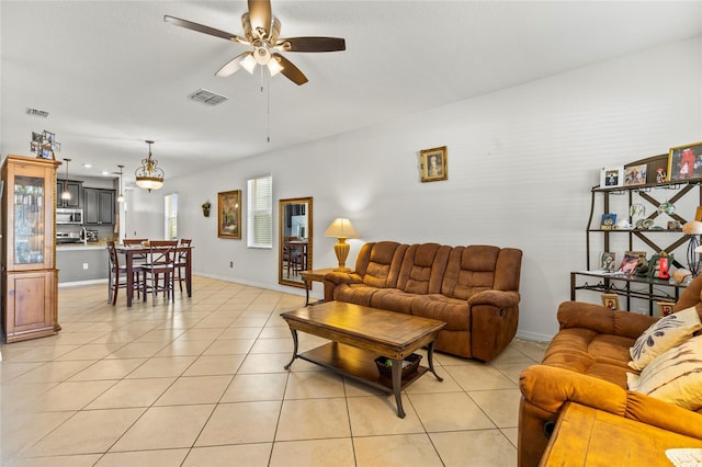 tiled living room featuring ceiling fan