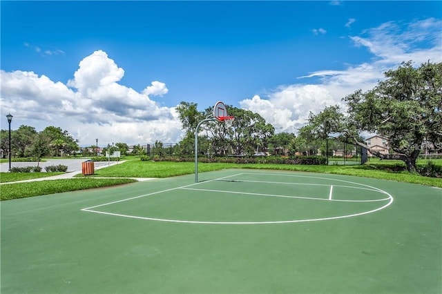 view of basketball court with a lawn