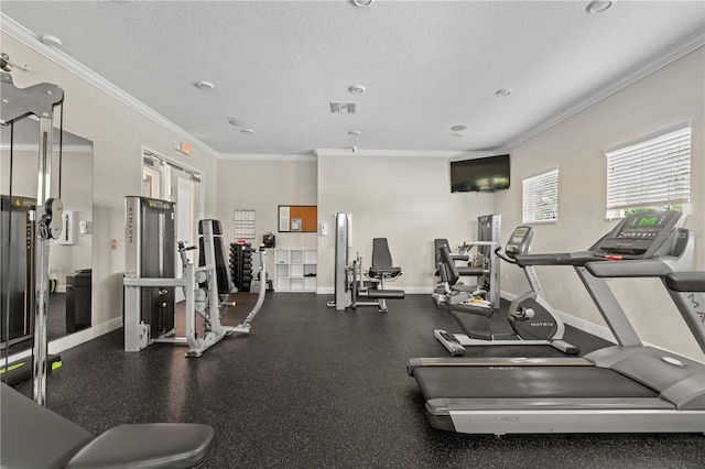 gym featuring a textured ceiling and ornamental molding