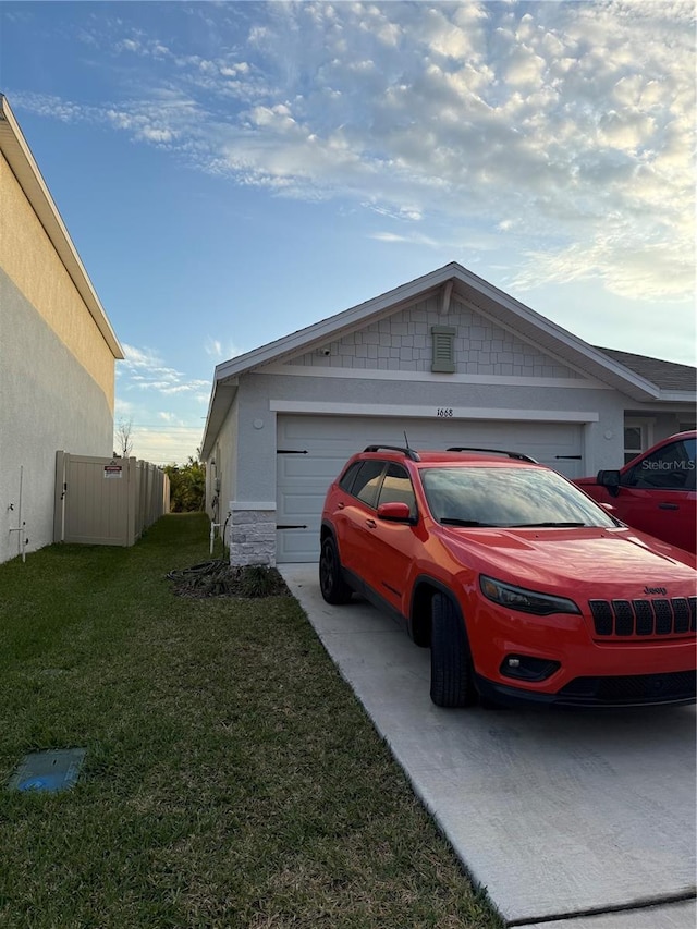 view of home's exterior featuring a lawn and a garage