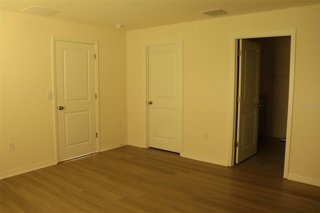 unfurnished bedroom featuring dark hardwood / wood-style flooring