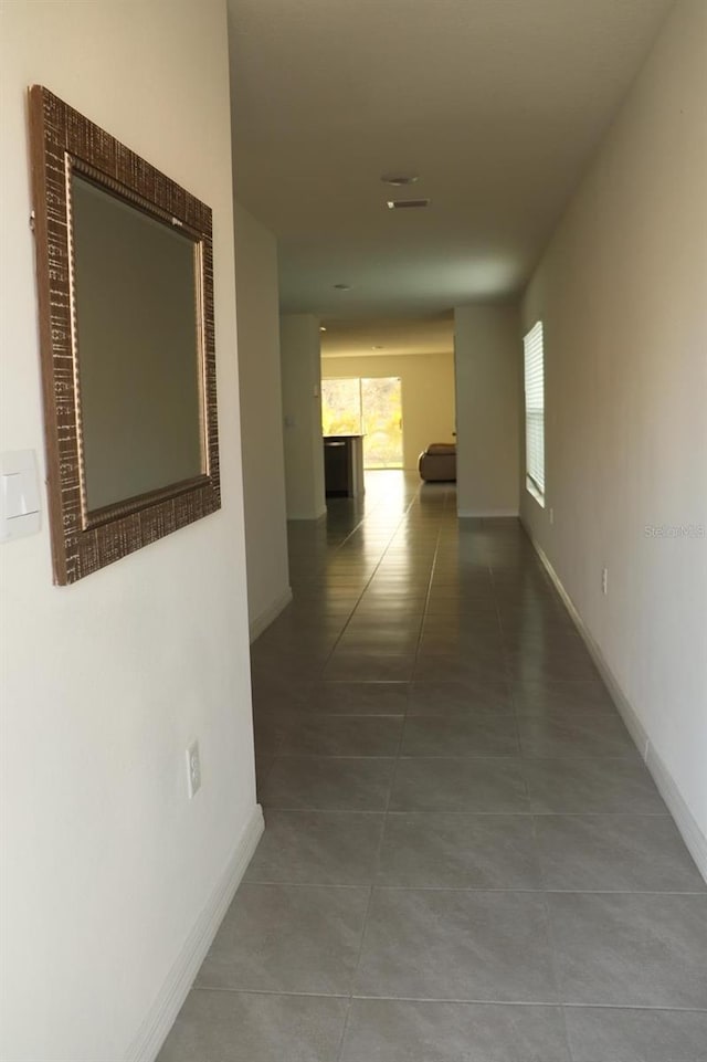 hallway with tile patterned floors