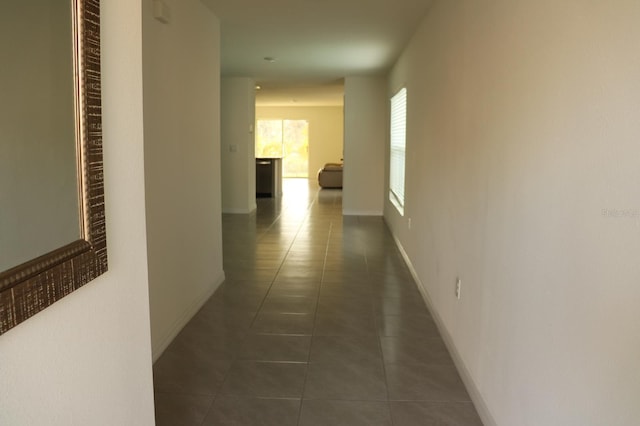 hallway with dark tile patterned floors