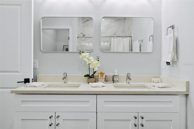 bathroom featuring vanity and curtained shower