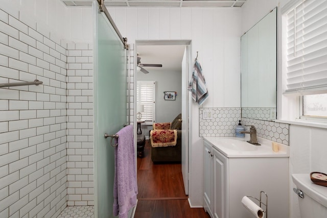 bathroom featuring decorative backsplash, an enclosed shower, vanity, wood-type flooring, and toilet