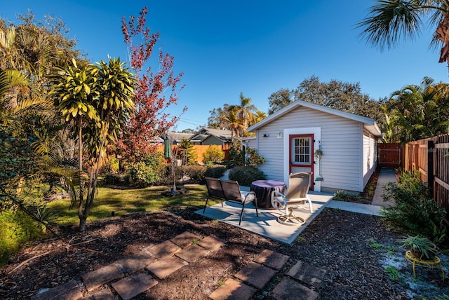 rear view of property featuring an outbuilding