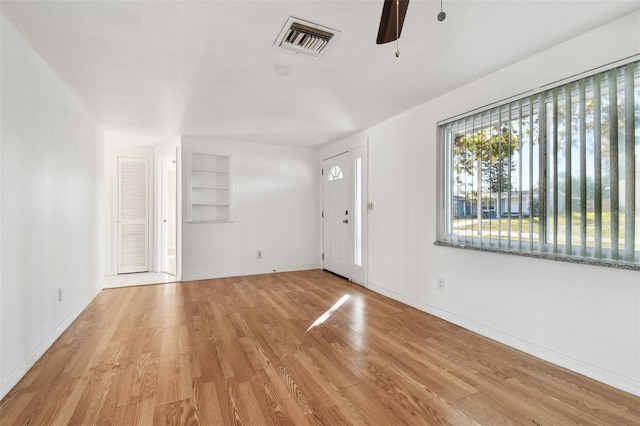 interior space with light wood-type flooring and ceiling fan