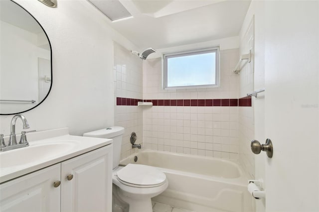 full bathroom featuring tile patterned flooring, vanity, toilet, and tiled shower / bath