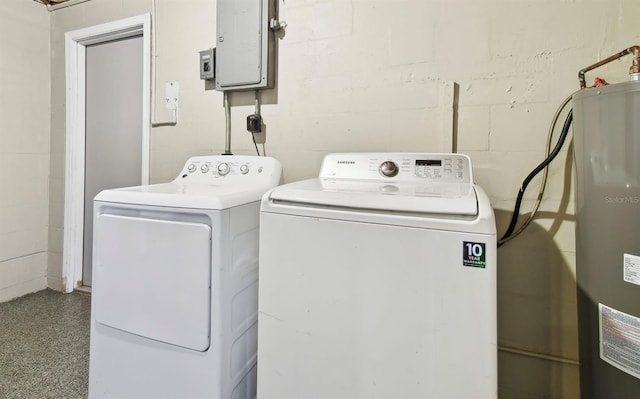 washroom featuring electric water heater, electric panel, and separate washer and dryer