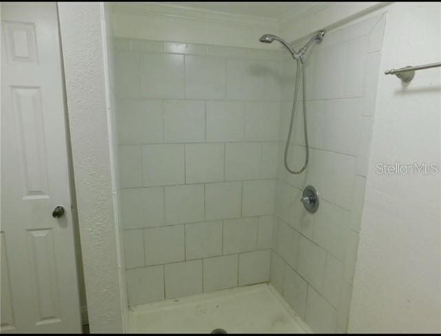 bathroom with tiled shower