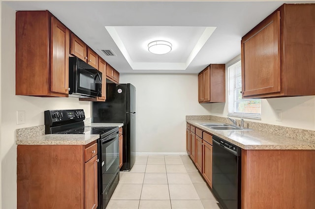 kitchen featuring black appliances, a raised ceiling, light tile patterned floors, and sink