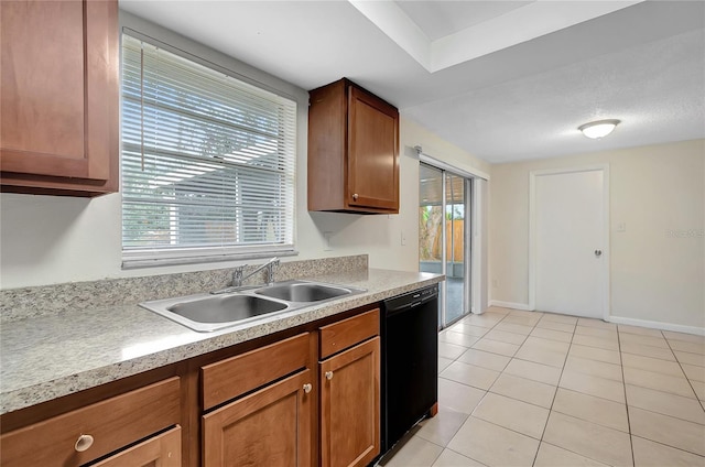 kitchen featuring light tile patterned flooring, sink, and black dishwasher