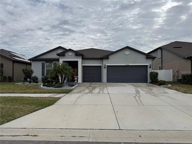 view of front of house with a garage and a front lawn