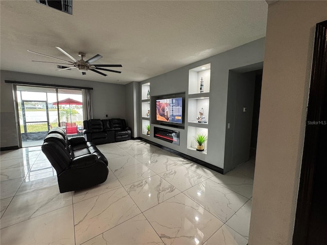 living room with a textured ceiling and ceiling fan