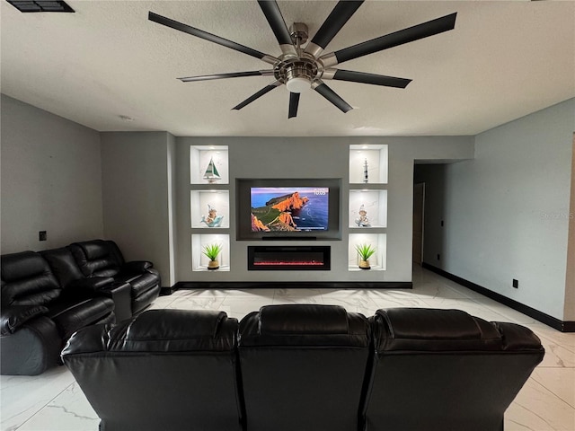 living room featuring ceiling fan, built in shelves, and a textured ceiling