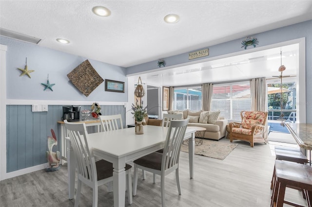 dining space featuring hardwood / wood-style floors and a textured ceiling