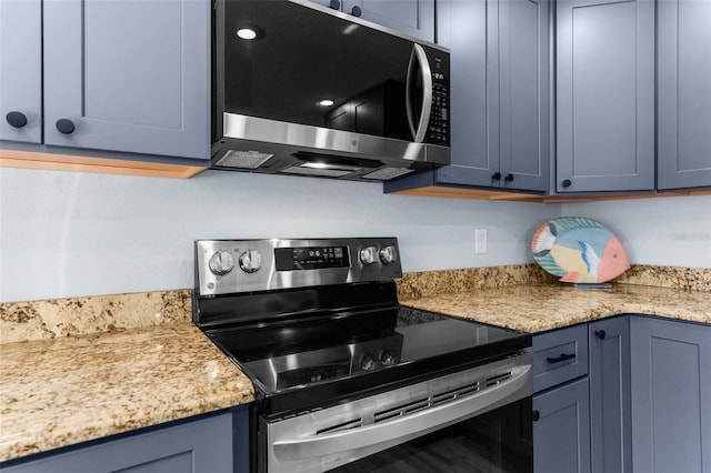 kitchen featuring stainless steel appliances and blue cabinets