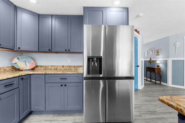 kitchen with light wood-type flooring and stainless steel fridge