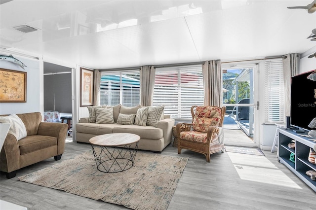 living room with ceiling fan and hardwood / wood-style flooring