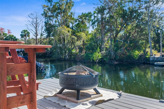 dock area featuring an outdoor fire pit and a water view