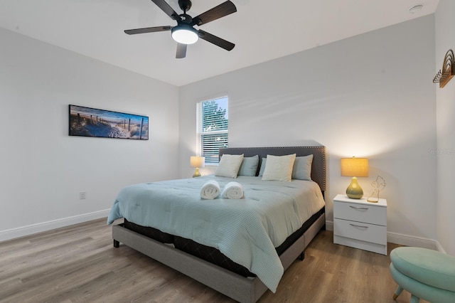 bedroom with ceiling fan and light hardwood / wood-style floors