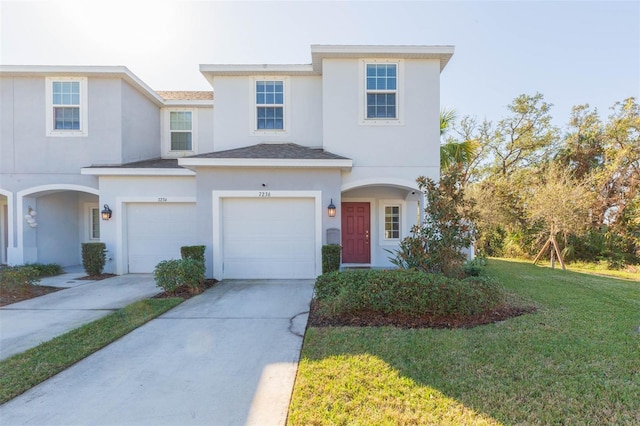 view of front of home featuring a garage and a front lawn