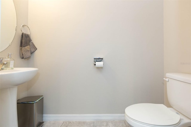 bathroom featuring tile patterned flooring and toilet