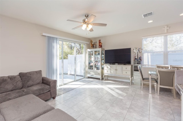 tiled living room featuring ceiling fan